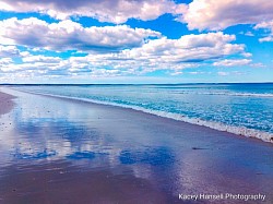 As the sky reflects off the wet sand