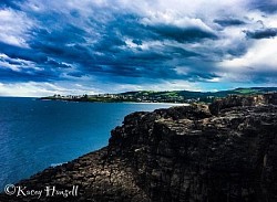 As the storm rolls in over the beach