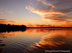 The clouds reflecting off the water at sunrise