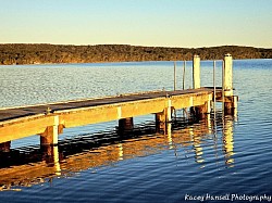 At the jetty reflecting in the clear calm water